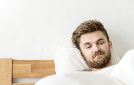 Men sleep on bed in the morning with in badroomの写真素材