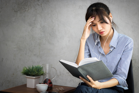 women holding book and thing in jobの写真素材
