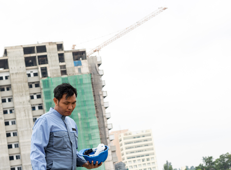 construction supervisor with building back ground