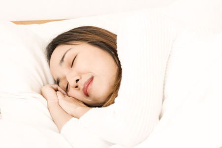 beautiful Asian women sleep on bed in bedroomの写真素材