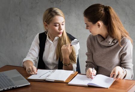business women talking job in office in morningの写真素材
