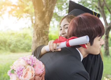 Asian female student  hug friend celebratingの写真素材