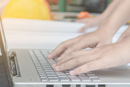 engineer or foreman type job on laptopの写真素材