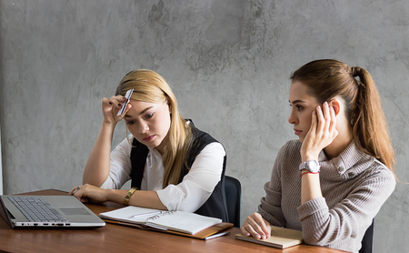 business women hlolding credit card and strain after shopping online