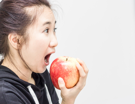 women eating red appleの写真素材