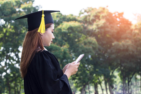 Asian female student graduate holding smart phone with check job