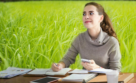 business women thinking job in office with in morning with  rice farm back groundの写真素材
