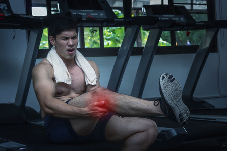 Man lag pain after workout in the morning.の写真素材