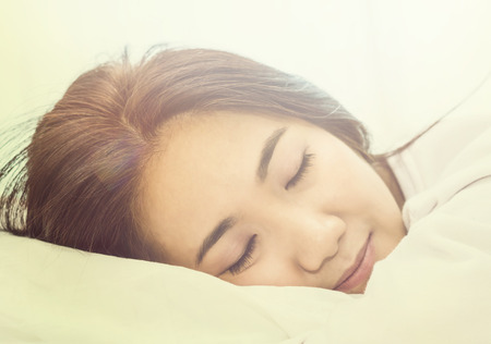 Asian woman sleep on  white pillow on bed in bedroom in holiday.happy relax timeの写真素材