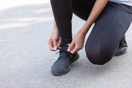 Close up Athlete running woman wearing Exercise pants and running shoe on the road,Runner woman...