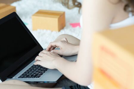 Asian women working with laptop for Online shopping at home with box for packaging in home,Own Small...