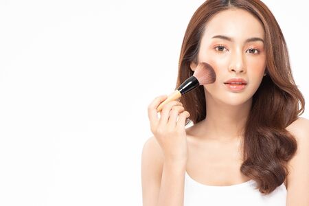 eauty asian woman  brown hair looking smile in camera happiness and hold make up brush  and cheerful with make up brush,Beauty Concept on white background.の写真素材