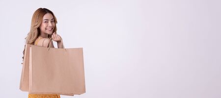 Happy asian woman holding shoppingbag with mid year sale.