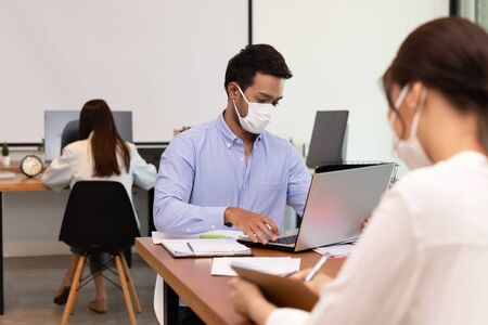 Asian business man and women talk about job and wear masks.New nomalの写真素材