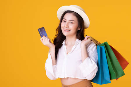 Happy asian woman holding shopping bag with mid year sale.