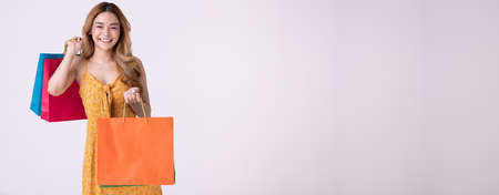 Happy asian woman holding shopping bag with mid year sale.の写真素材