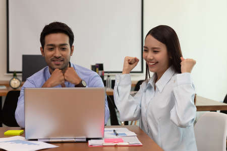 Asian business man and woman meeting and talk about job and happy.の写真素材