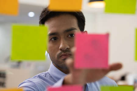 Businessman poin job on bord in office.の写真素材