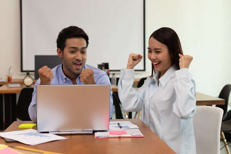 Asian business man and woman meeting and talk about job and happy.