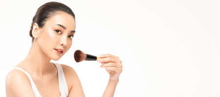 Beauty asian woman hold make up brush  and cheerful with make up brush