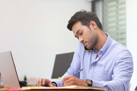 Business asian man happy working job on laptop in office.の写真素材