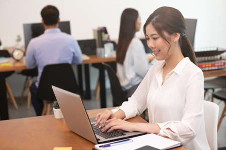 Business asian woman happy working job on laptop in office.の写真素材