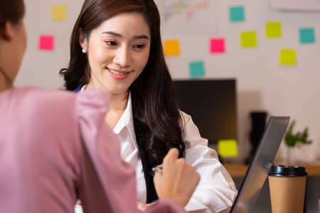 Asian business woman talk about job on labtop in business meeting.