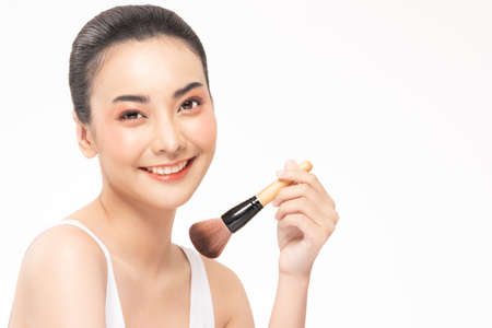 Beauty asian woman hold make up brush  and cheerful with make up brushの写真素材