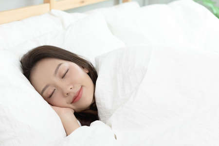 Asian women sleeping and sweet dream on white bed in bedroomの写真素材