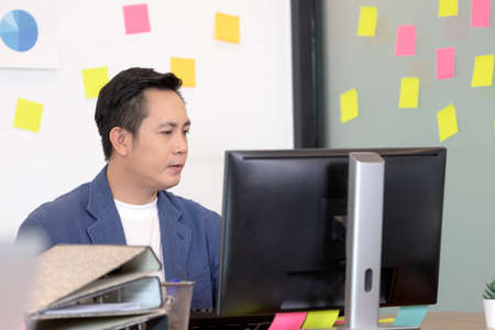 business asian men working on computer in officeの写真素材