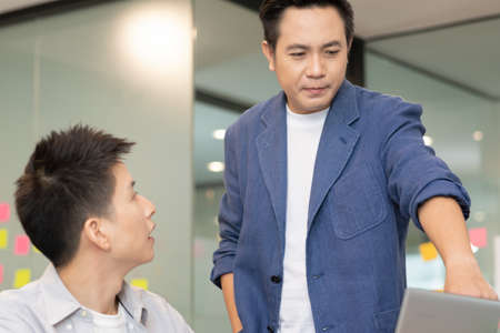 Asian Startup business man  standing and talk about job in morning.の写真素材
