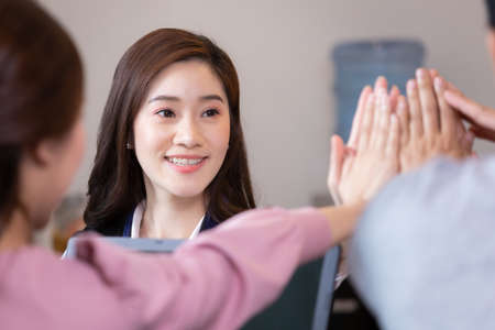 Business man and woman join hands for branding in office.