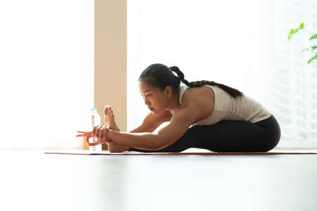 Asian woman pilates exercise yoga in home.