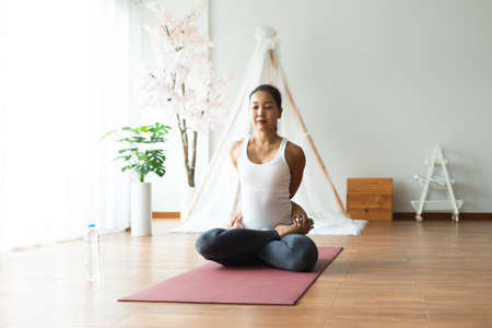 Asian woman pilates exercise yoga in home.