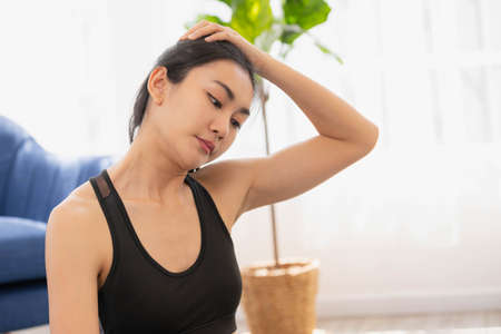 Close up Hand and face, Asian woman does morning yoga, sitting in Easy position, Sukhasana posture, and meditating.の写真素材