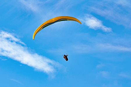 paraglider on the background of bright blue skyの写真素材
