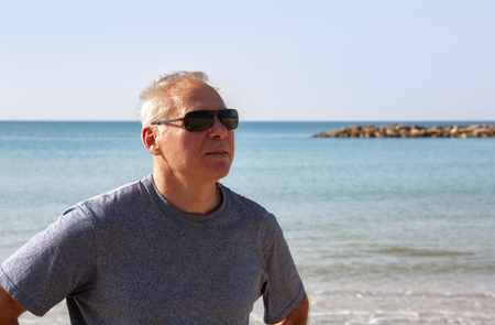 Portrait of a man of retirement age on the background of the seaの写真素材