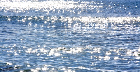 sun glare, shimmering on the surface of the waterの写真素材