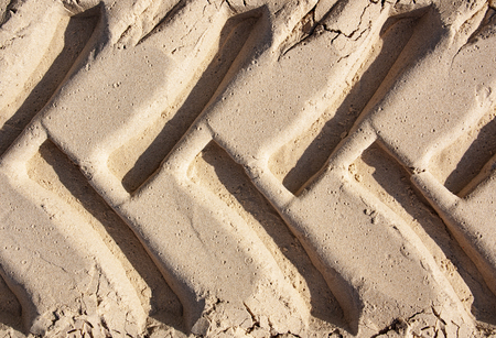 the track of the tractor wheels in the sand Shot close-upの写真素材
