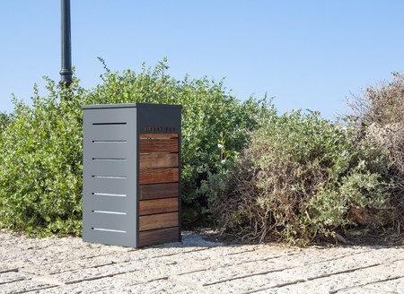 street trash can made of metal and woodの写真素材