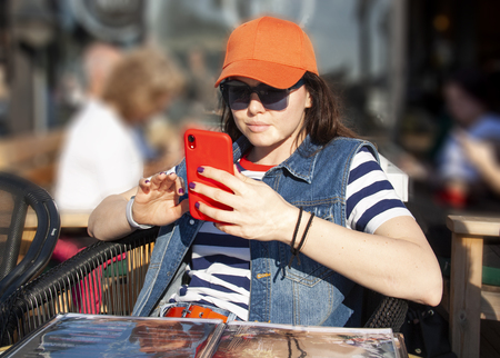 Modern girl writes a message on a cell phoneの写真素材