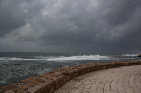 promenade on the fortress wall overlooking the sea on a gloomy dayの写真素材