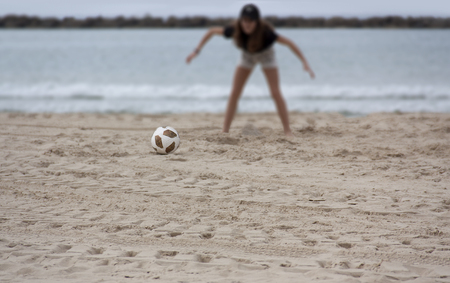 The ball on the blurred background of a girl standing in a goalkeeper poseの写真素材