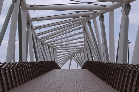 a fragment of a structure made of metal pipes on the background of a cloudy sky