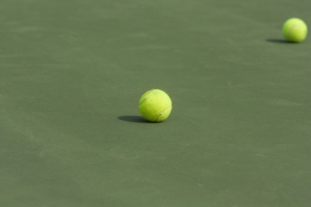tennis balls on the court as backgroundの写真素材