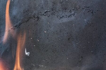Smoke and flame on textured black metal as background