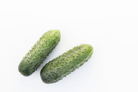 Two fresh cucumbers were shot close-up on a white backgroundの写真素材
