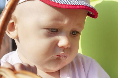 The baby looks sad and upset close-up