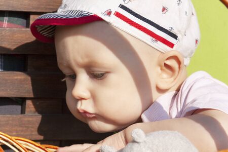 The baby looks curiously into the basketの写真素材