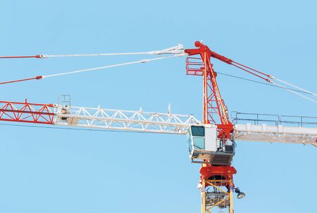 Part of construction crane with cabin on sky background